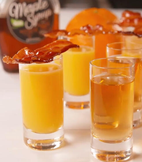 Wake N Bacon equal parts whiskey & butterscotch liqueur orange juice chaser with maple bacon garnish (not cooked in Wake N Bacon... too sus)